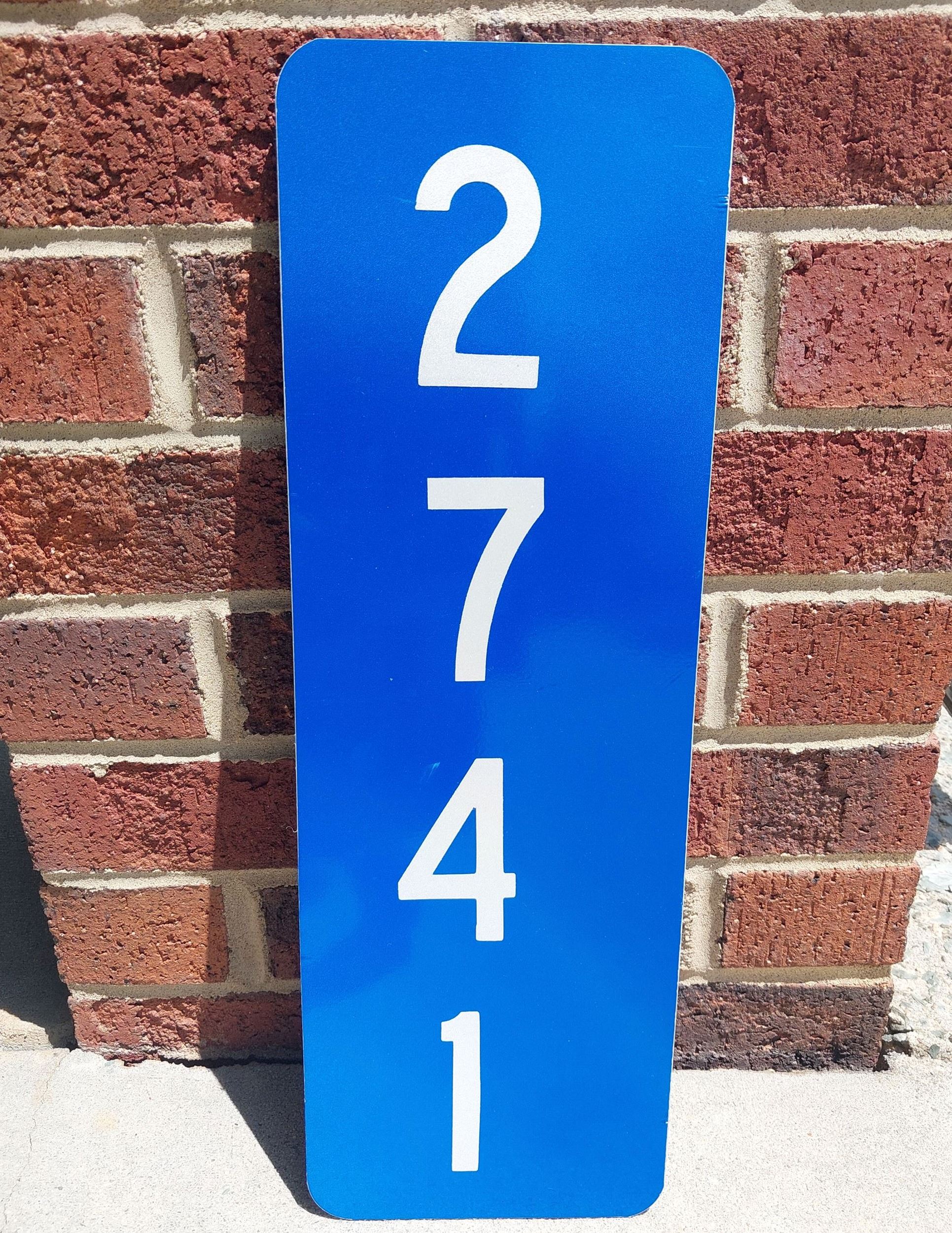 The Fire Department provides blue signs with white numbers if purchased.