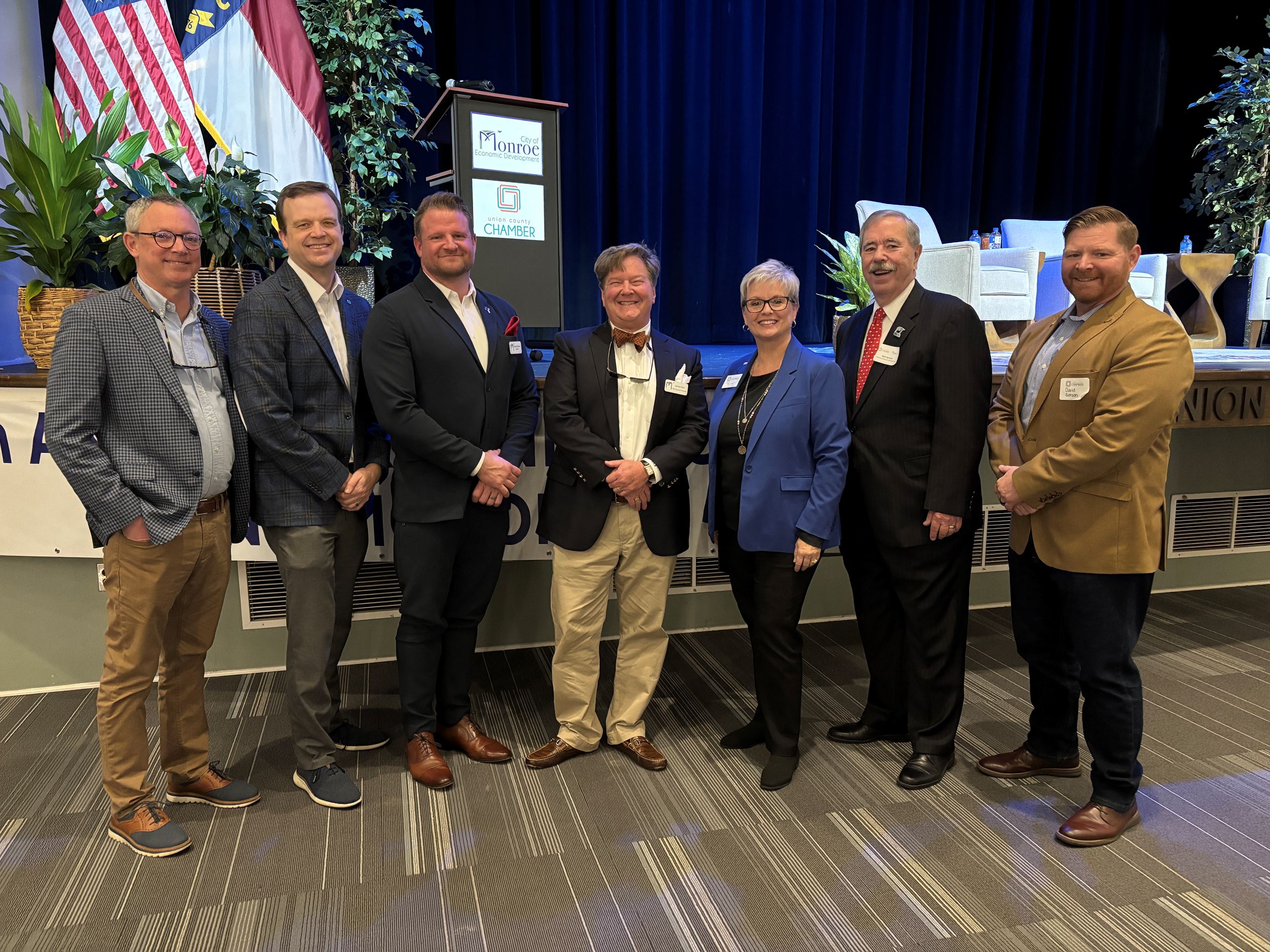 A group of presenters standing in front of the stage