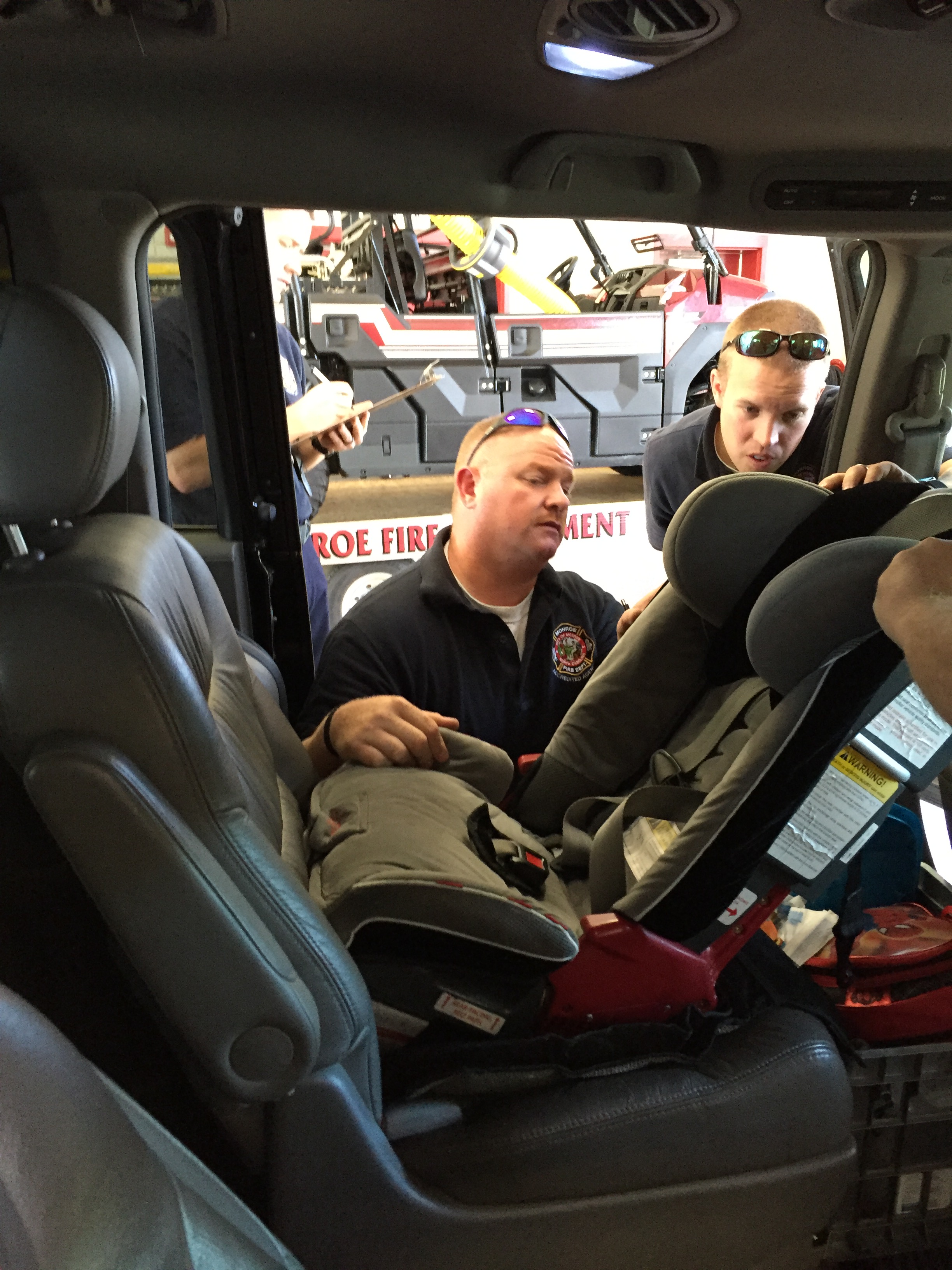 Firefighters installing a child car seat